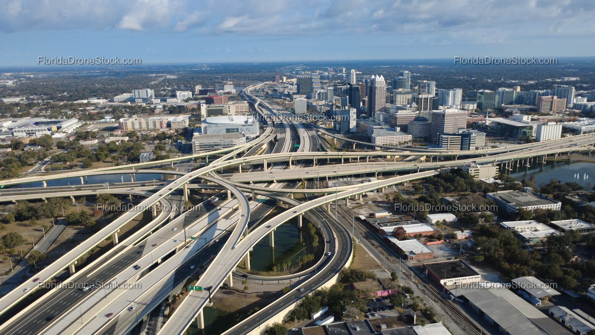 Mid-altitude winter still I-4 408 interchange with Downtown Orlando skyline The Vue cumulus cloud ceiling